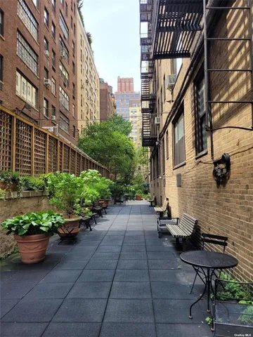 a view of a street with potted plants