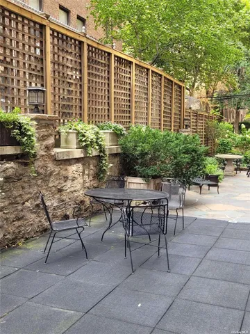 a backyard of a house with outdoor seating