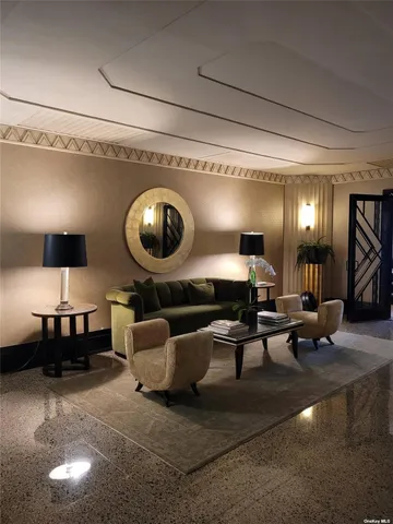 a living room with furniture and a lamp