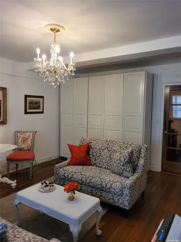 a living room with furniture and a chandelier