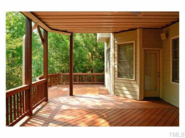 7108 Rippling Stone Lane Raleigh, NC 27612 - Photo 21 of 25 The downstairs deck is very private and spacious.