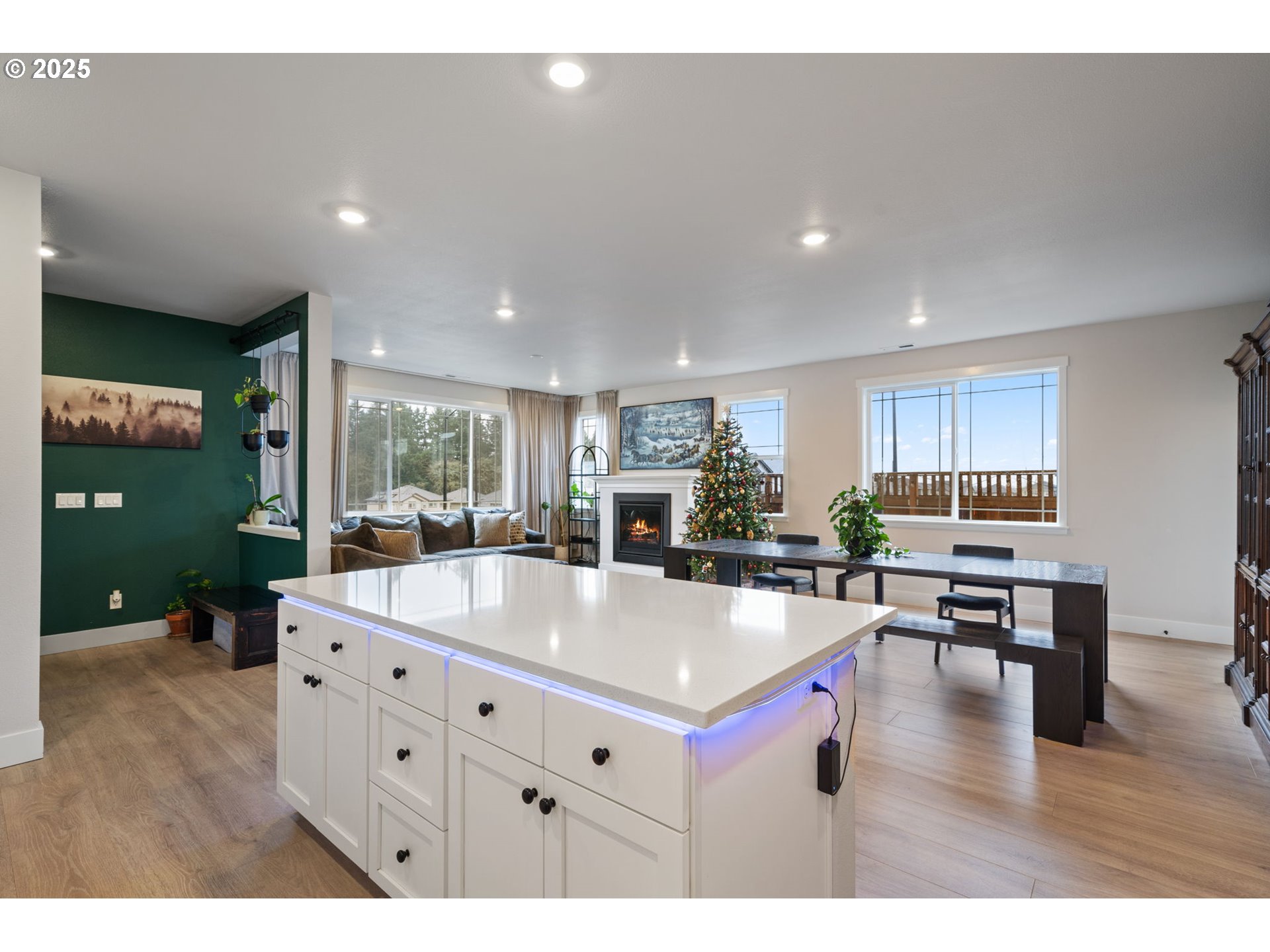 16719 Southwest Beemer Lane Portland, OR 97224 - Photo 11 of 47 a living room with stainless steel appliances kitchen island lots of furniture a chandelier wooden floor and a view of kitchen