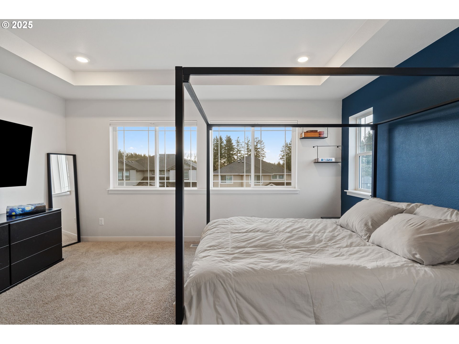 16719 Southwest Beemer Lane Portland, OR 97224 - Photo 20 of 47 a bedroom with a bed and a flat screen tv