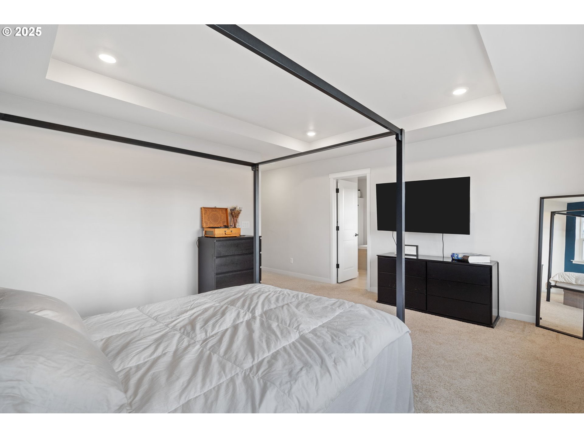 16719 Southwest Beemer Lane Portland, OR 97224 - Photo 21 of 47 a bedroom with a bed and a flat screen tv