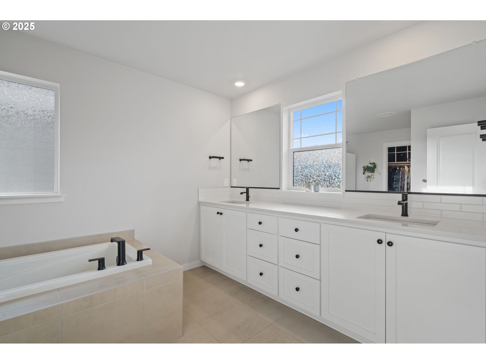 16719 Southwest Beemer Lane Portland, OR 97224 - Photo 25 of 47 a bathroom with a double vanity sink and mirror with window