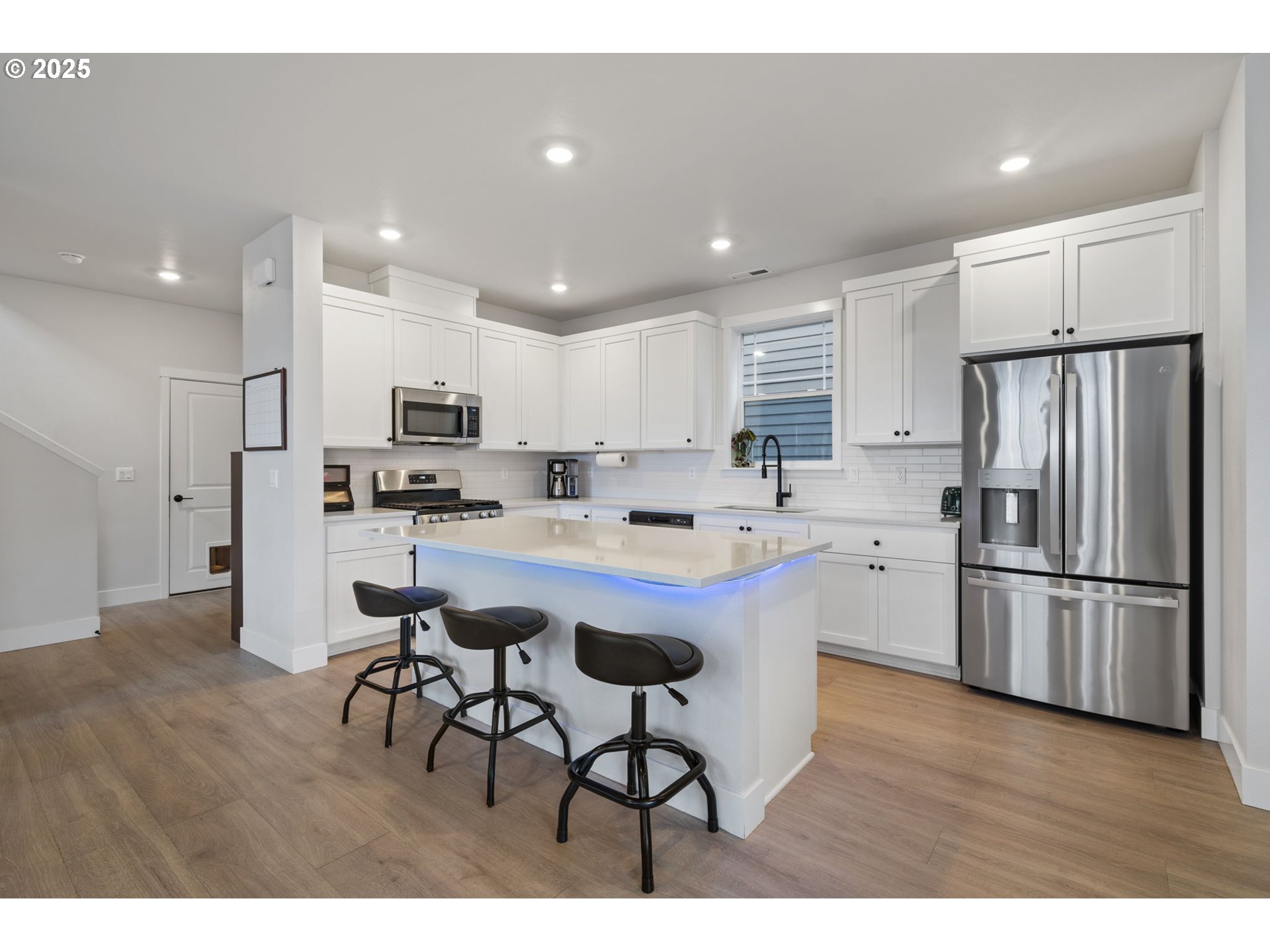 16719 Southwest Beemer Lane Portland, OR 97224 - Photo 7 of 47 a kitchen with stainless steel appliances granite countertop a refrigerator a sink dishwasher a stove and white cabinets with wooden floors