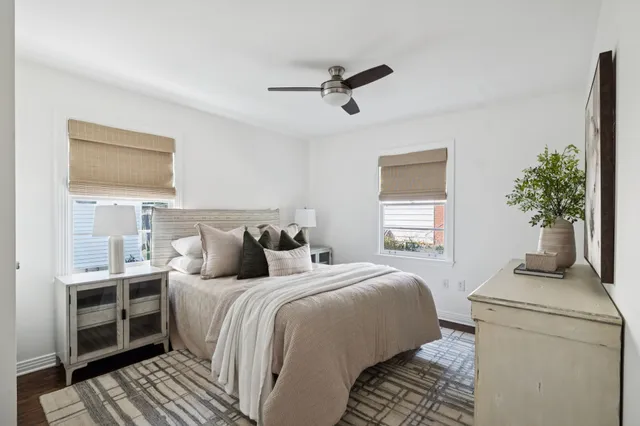 a bedroom with a bed and a potted plant