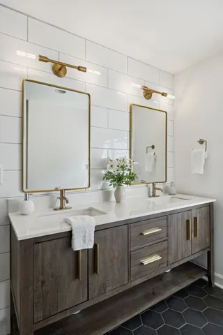 a bathroom with a double vanity sink mirror and