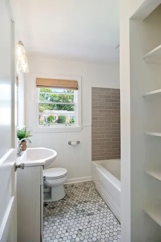 a bathroom with a sink toilet and shower