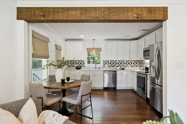 a kitchen with white cabinets and white appliances