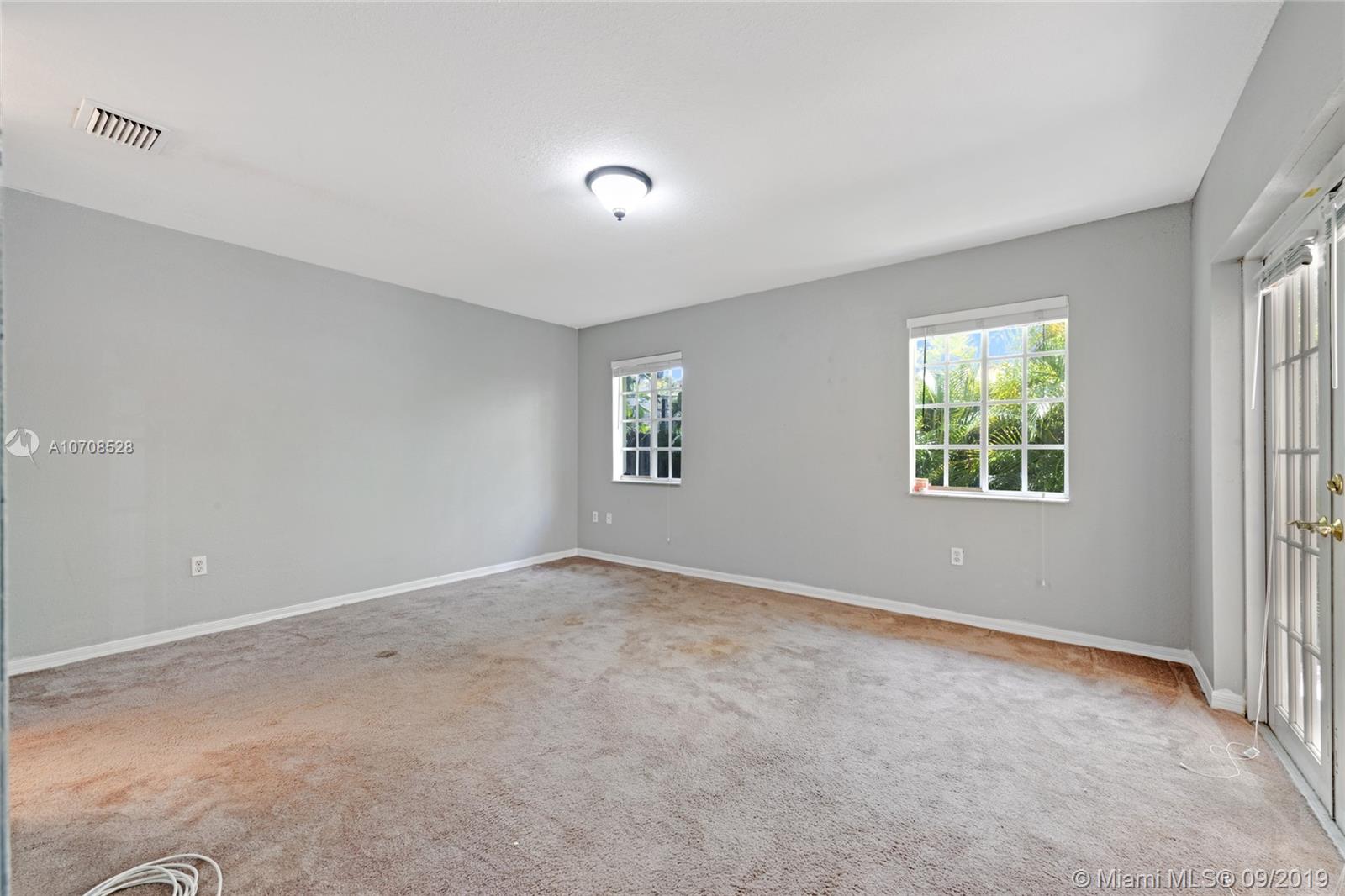 3540 Southwest 13th Street Miami, FL 33145 - Photo 9 of 27 master bedroom with french doors leading out to the backyard