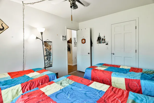 a bedroom with a bed and a chandelier
