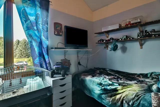 a room with water heater and wooden floor