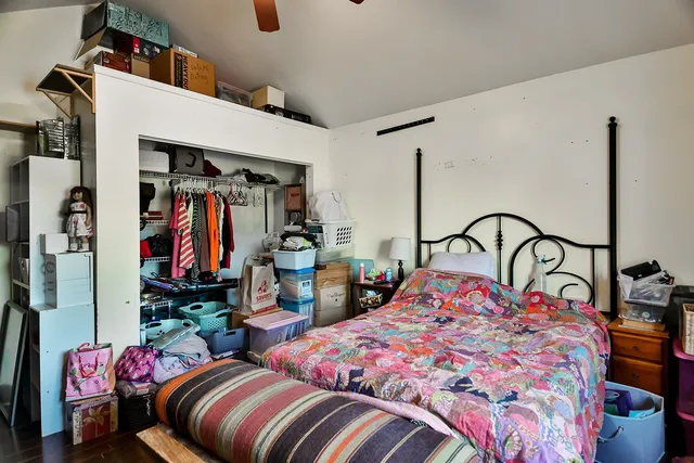 a bedroom with two beds and a closet