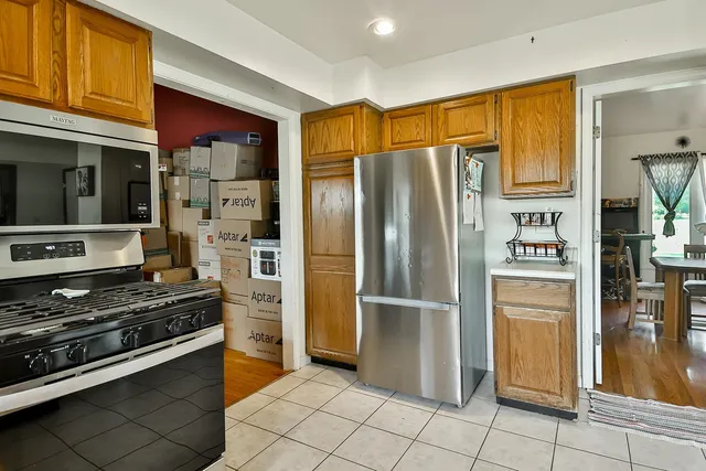 a kitchen with stainless steel appliances granite countertop a refrigerator and a stove top oven