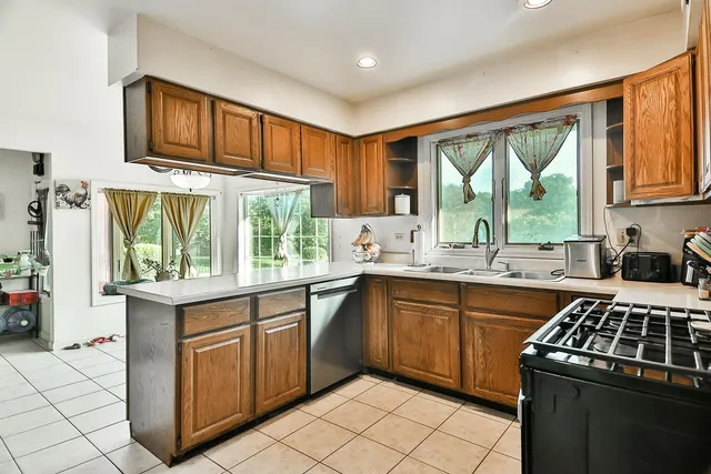 a kitchen with a stove sink and cabinets