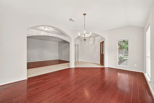 an empty room with closet and windows