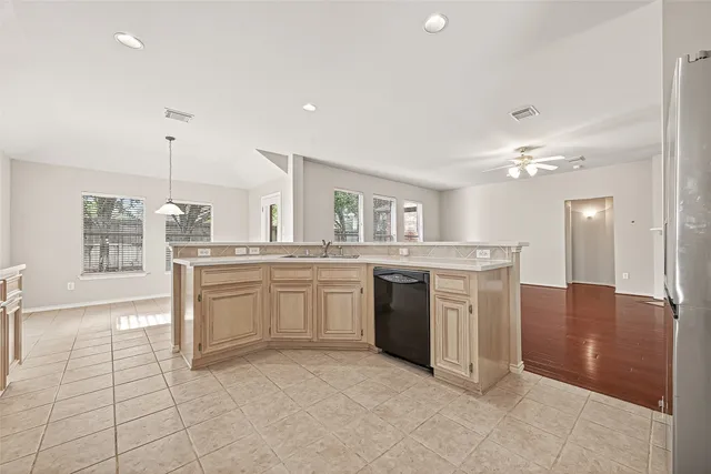 a kitchen with stainless steel appliances granite countertop a refrigerator and a sink
