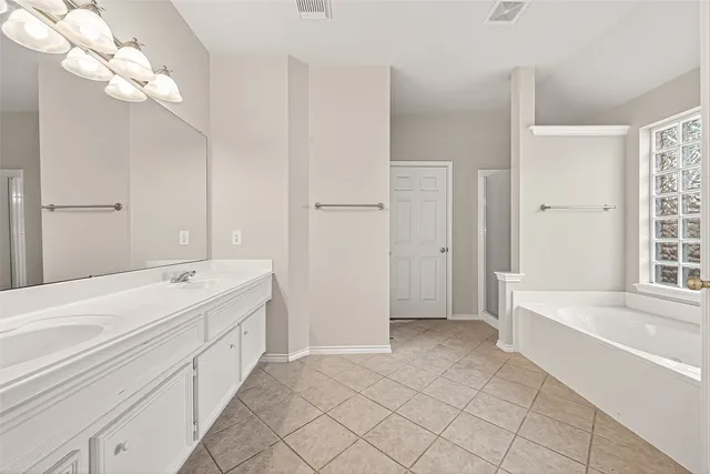 a bathroom with a bathtub and a shower