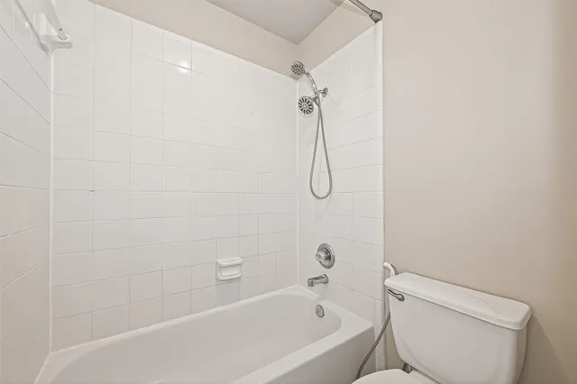 an empty room with closet and fan