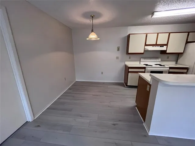 a kitchen with a sink a stove and cabinets