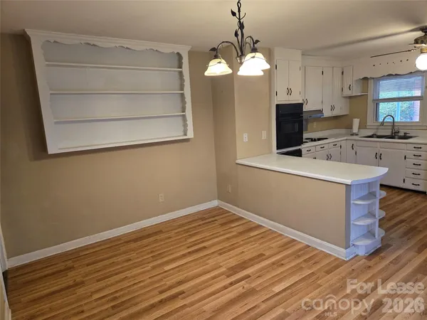 a view of a kitchen with microwave and cabinets
