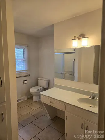 a bathroom with a sink a toilet and mirror