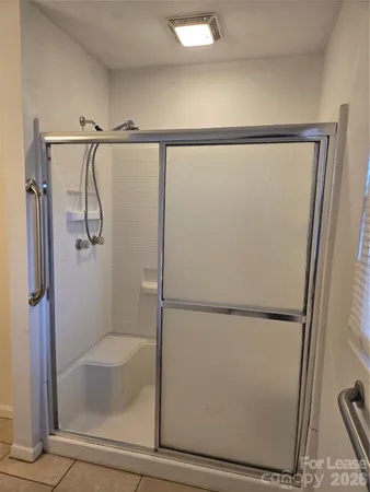 a bathroom with a glass shower door