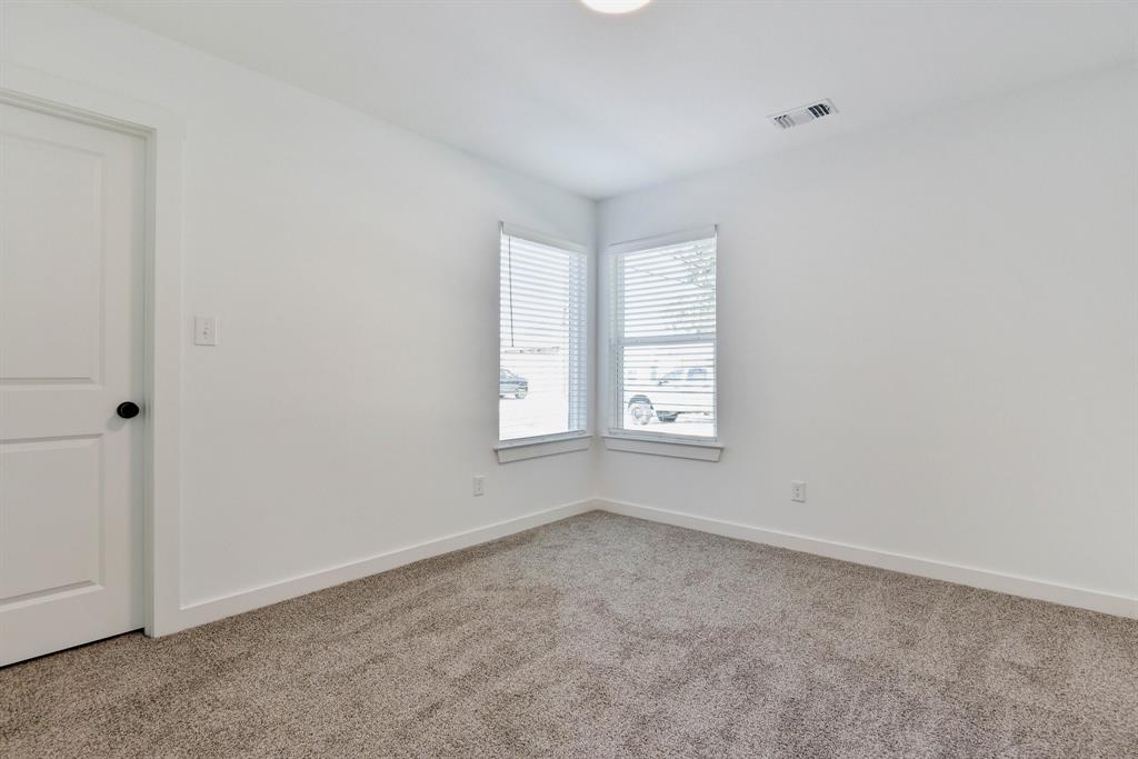 103 East Bond Street Denison, TX 75021 - Photo 11 of 21 an empty room with windows