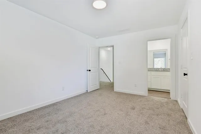 an empty room with closet and windows