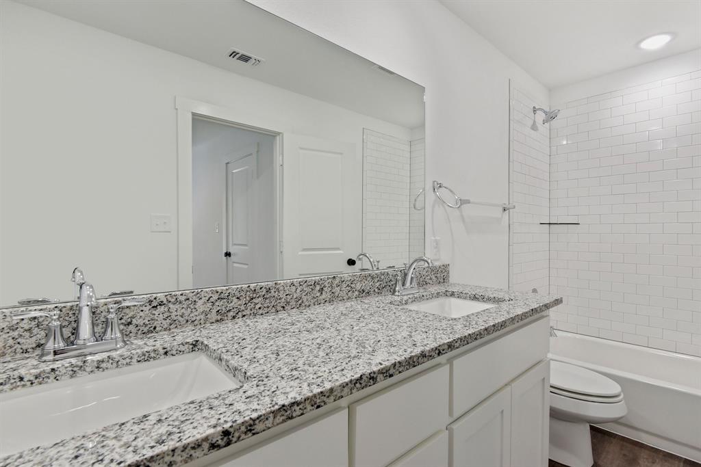 103 East Bond Street Denison, TX 75021 - Photo 16 of 21 a bathroom with a granite countertop sink and a mirror