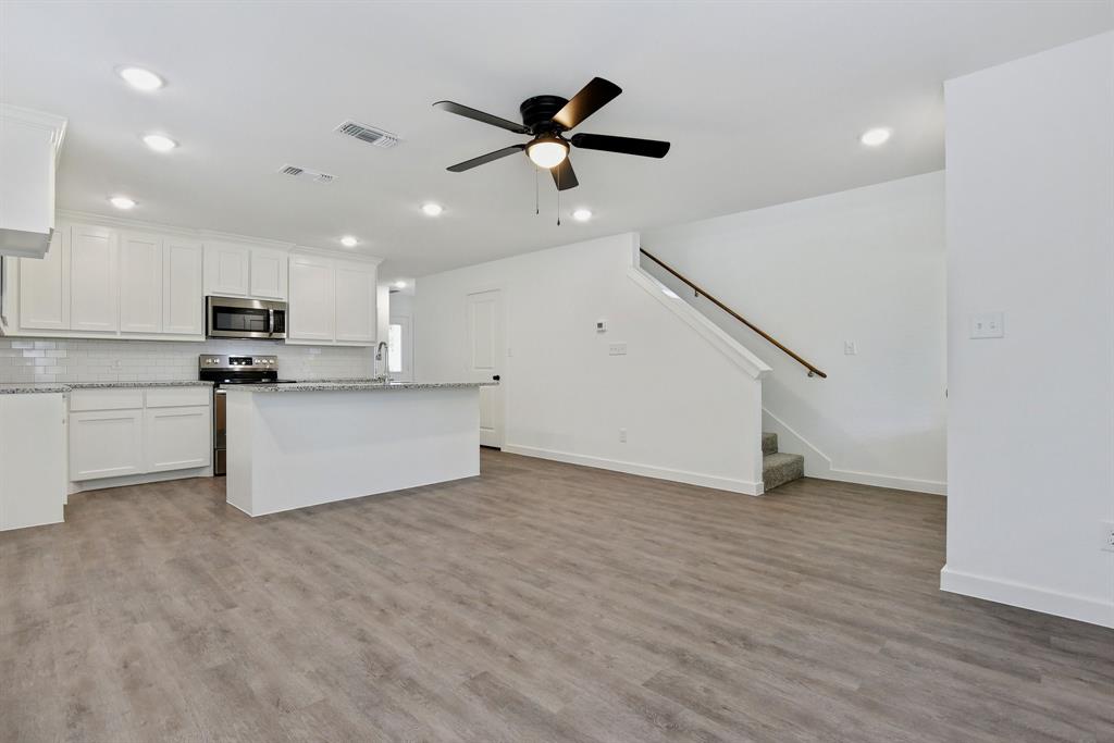 103 East Bond Street Denison, TX 75021 - Photo 5 of 21 a view of kitchen with stainless steel appliances wooden floor and living room view