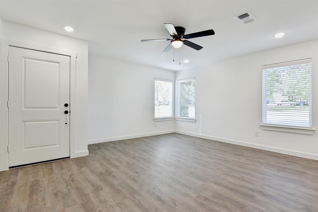 103 East Bond Street Denison, TX 75021 - Photo 7 of 21 a view of empty room with wooden floor and fan