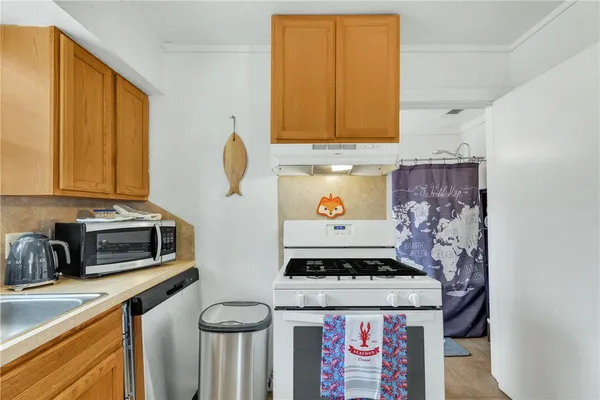 a kitchen with stainless steel appliances granite countertop a stove and a microwave