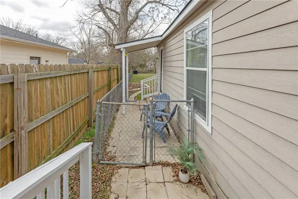 a view of balcony with wooden floor and seating space