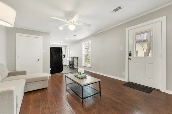 a living room with furniture and wooden floor