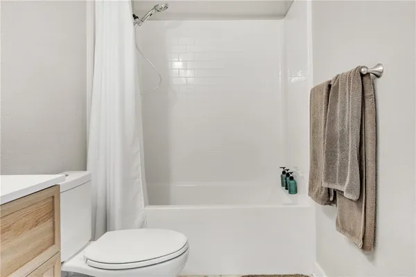 a bathroom with a toilet and a bathtub