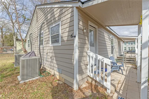a view of a house with a door and wooden bench