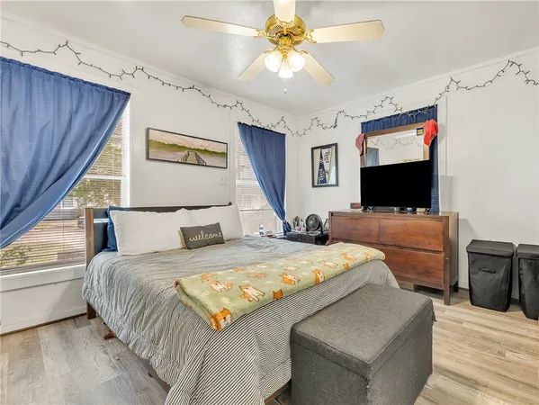 a bedroom with a bed and a flat screen tv