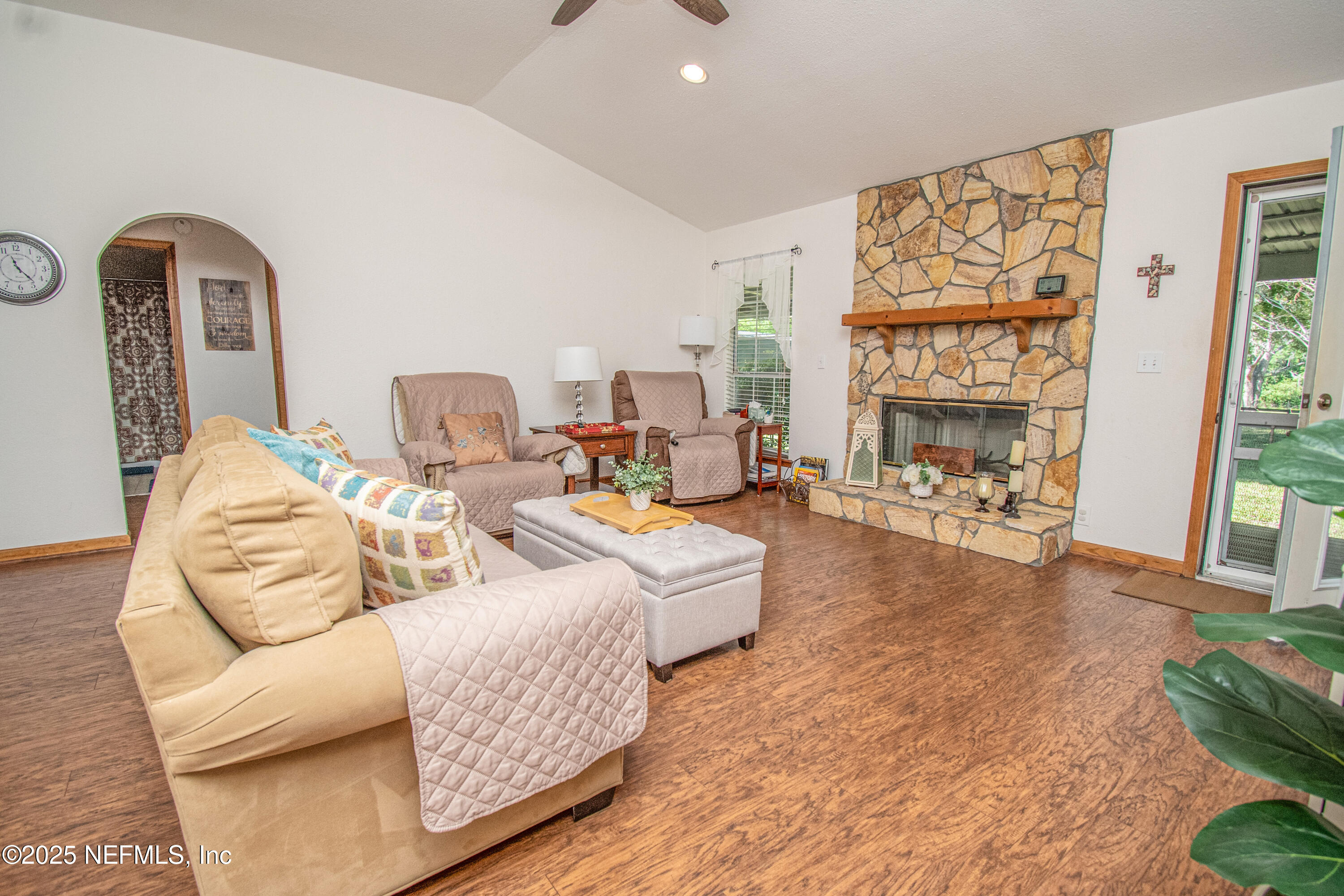 6485 Ray Phillips Road Macclenny, FL 32063 - Photo 18 of 27 a living room with furniture fireplace and a large window