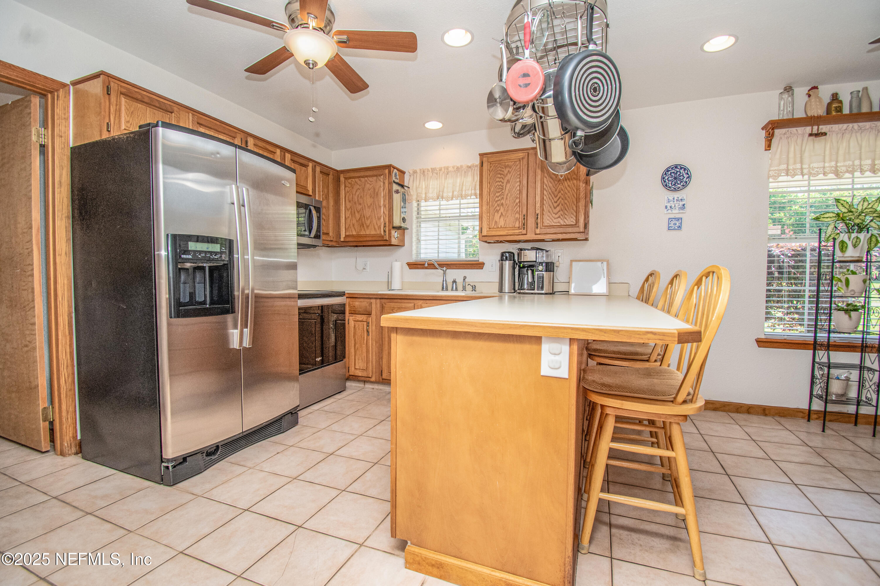 6485 Ray Phillips Road Macclenny, FL 32063 - Photo 20 of 27 a kitchen with stainless steel appliances granite countertop a sink and a refrigerator