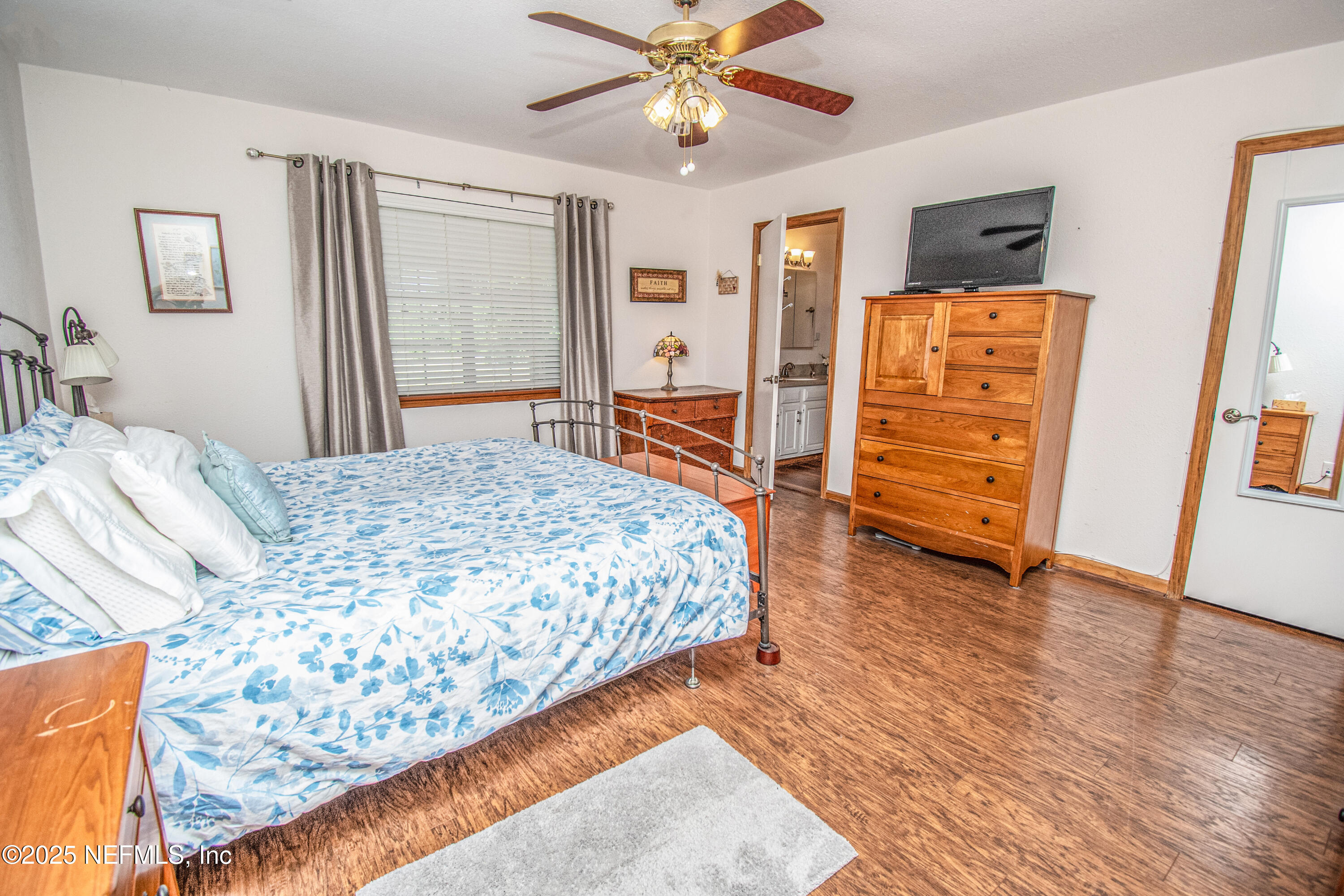 6485 Ray Phillips Road Macclenny, FL 32063 - Photo 22 of 27 a bedroom with a bed and wooden floor