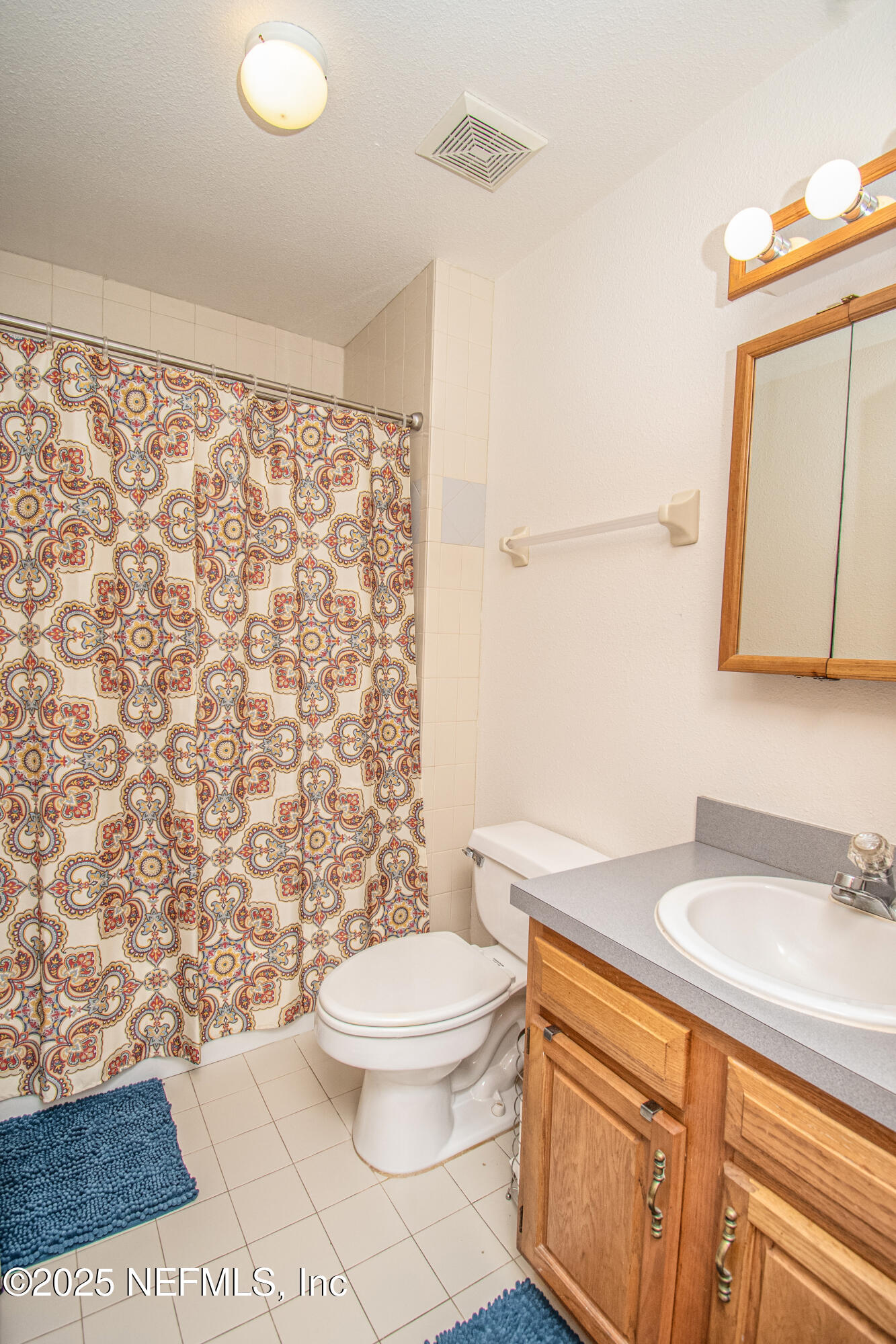 6485 Ray Phillips Road Macclenny, FL 32063 - Photo 25 of 27 a bathroom with a granite countertop toilet sink and mirror