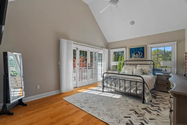 a spacious bedroom with a bed and a window