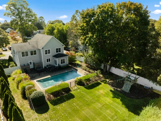 a view of a house with swimming pool and sitting area