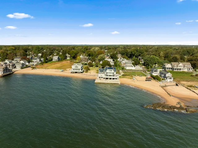 an outdoor space with lots of residential buildings ocean and mountain view in back