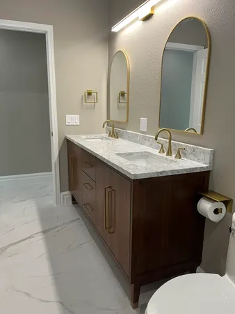 a bathroom with a granite countertop sink toilet and a mirror