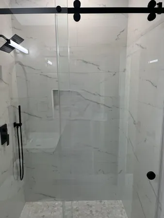 a bathroom with a sink vanity mirror and toilet