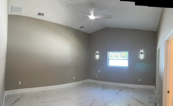 an empty room with closet and a window