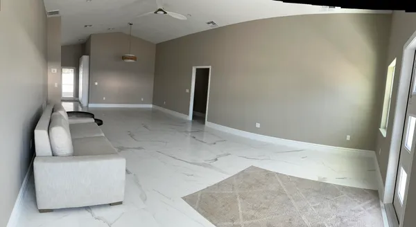 a living room with furniture and a chandelier